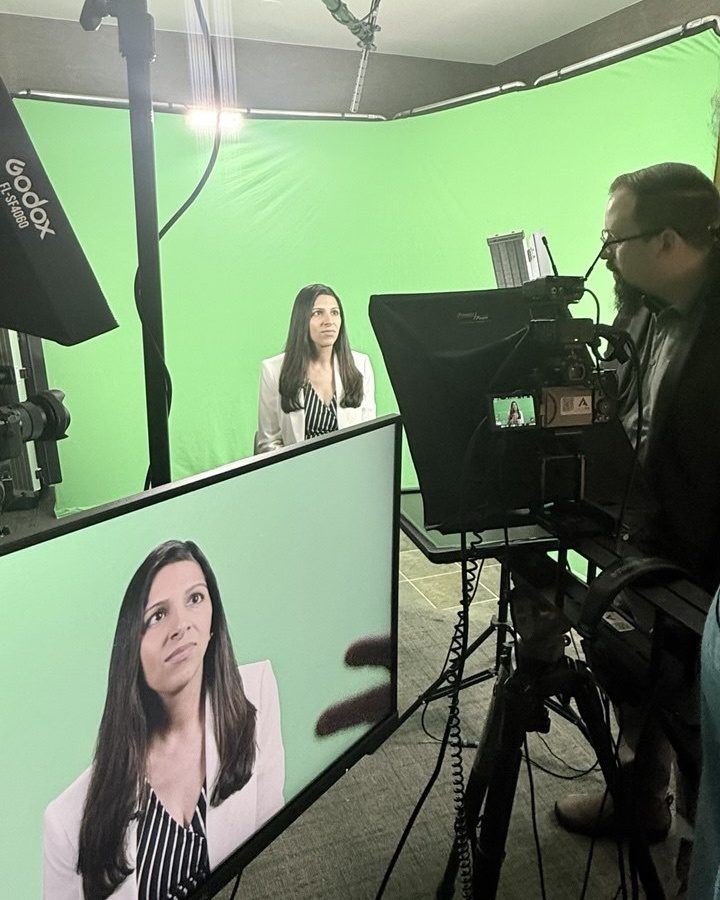 Dr. Priya Mathews being filmed for an interview in a studio