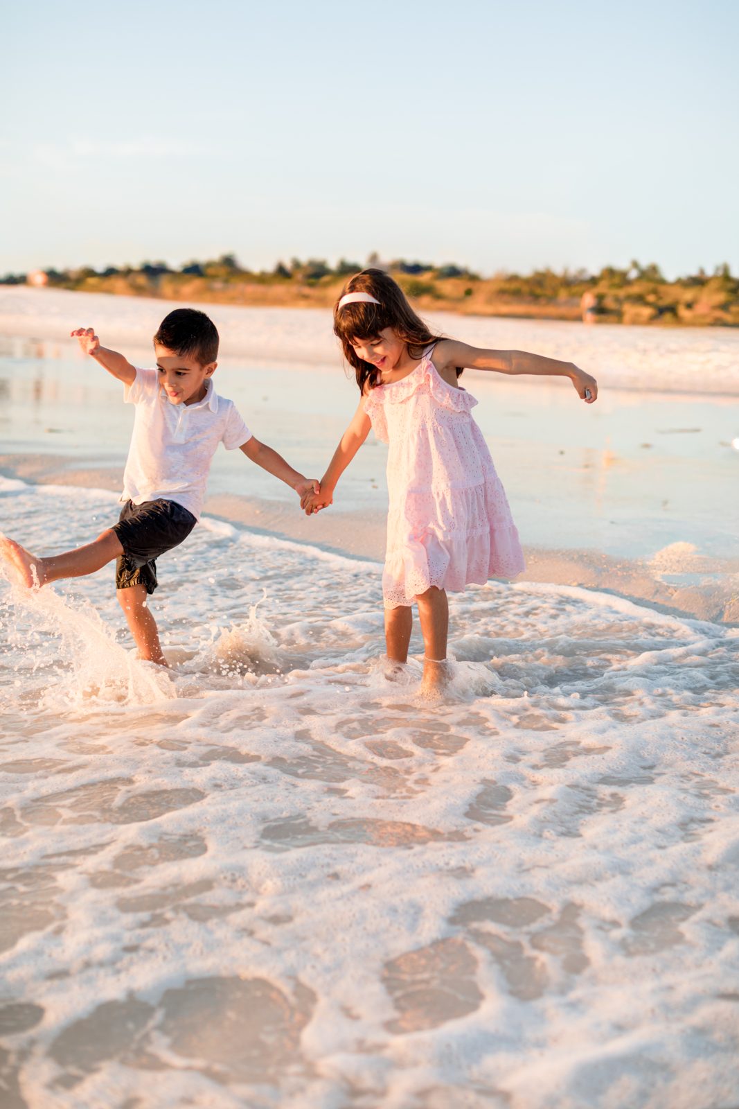 Dr. Priya Mathews' two children playing in the waves
